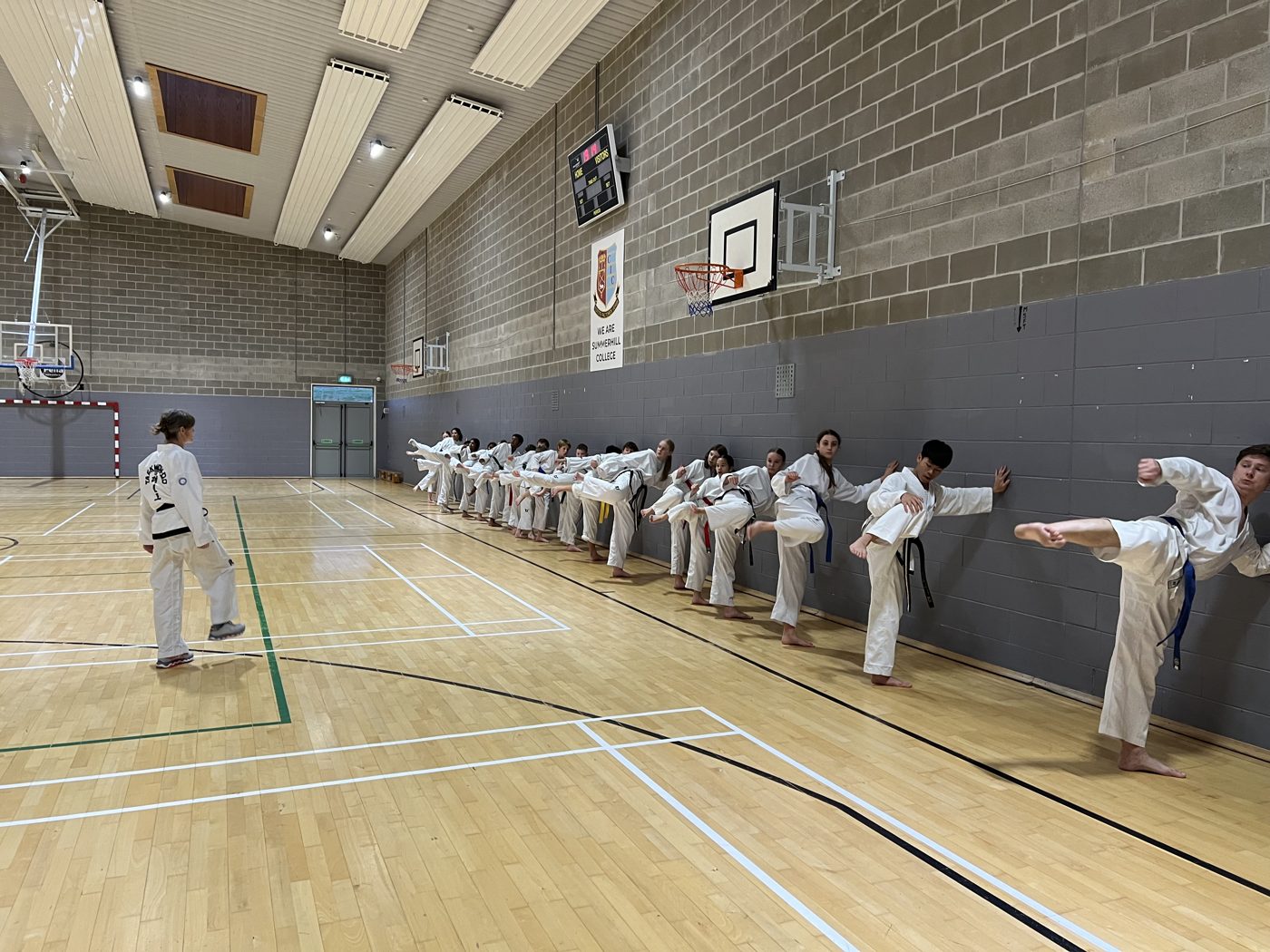 Kicking drills across the hall, everyone at their own level