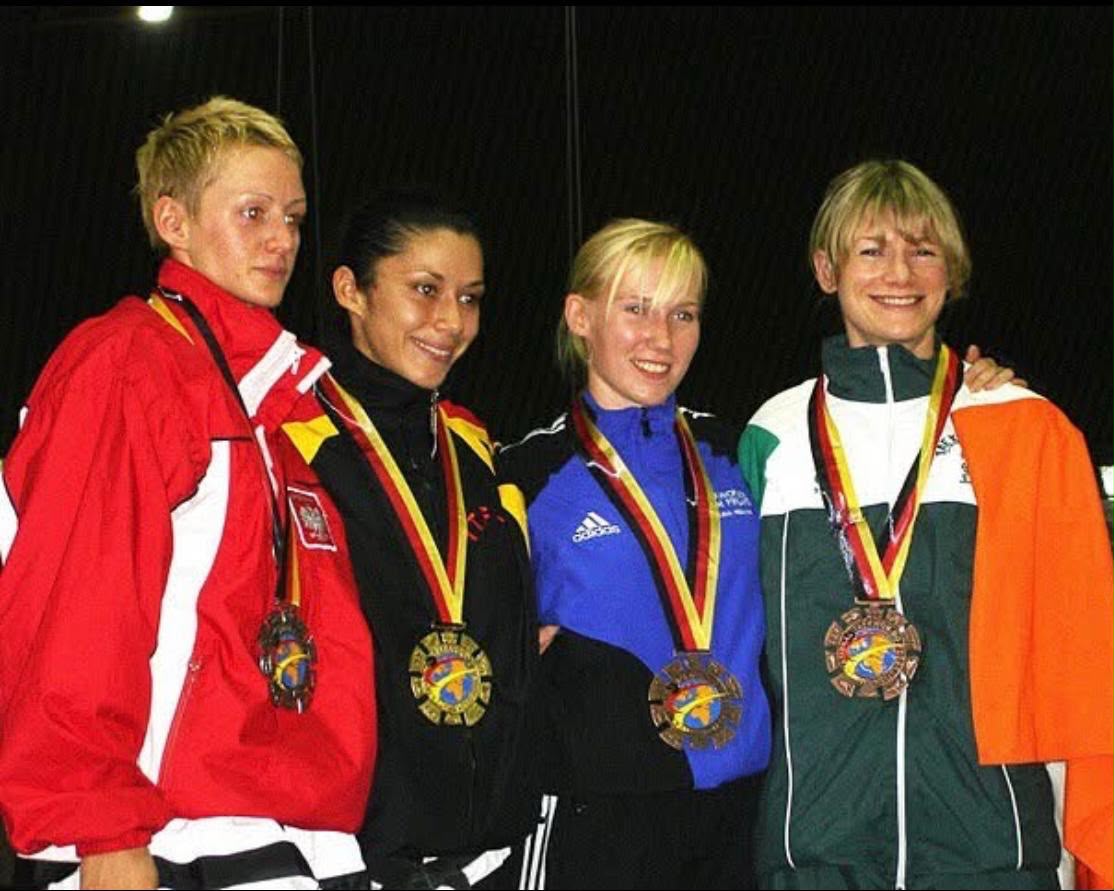 Coach Nicola on the world podium for Ireland — the standard she now coaches to